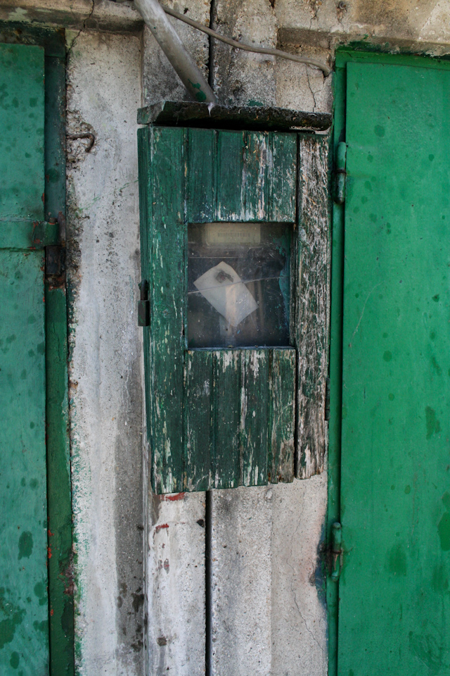 Green metal doors closeup